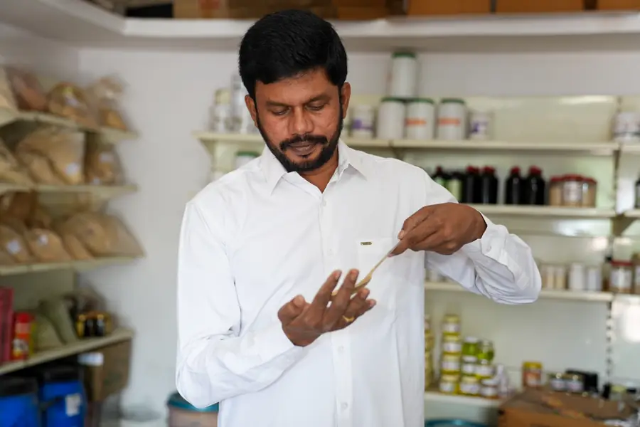 Dr. Krishna examining a dried root in the dispensary